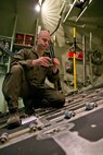 U.S. Air Force Reserve Master Sgt. Tim Brown, a loadmaster assigned to the 327th Airlift Squadron, inspects extraction link components of the tow plate during a preflight inspection in a C-130J fuselage trainer at the U.S. Air Force C-130 Aircrew Training System schoolhouse at Little Rock Air Force Base, Ark., Feb. 16, 2016. Brown is in upgrade training as part of the 913th Airlift Group’s transition from the “H” model to the “J” model. (U.S. Air Force photo by Master Sgt. Jeff Walston/Released)