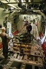 Mike Luetgers (Center), a loadmaster instructor, checks an air drop pallet during a preflight inspection in a C-130J fuselage trainer at the U.S. Air Force C-130 Aircrew Training System schoolhouse at Little Rock Air Force Base, Ark., Feb. 16, 2016. The 913th Airlift Group is transitioning from the C-130H Hercules to the C-130J Super Hercules, and aircrew personnel from the group use the FuT during the process of retraining and gaining certification on the new airframe. (U.S. Air Force photo by Master Sgt. Jeff Walston/Released)