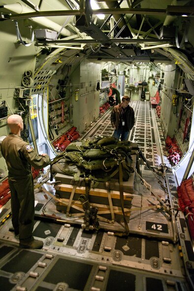 Mike Luetgers (Center), a loadmaster instructor, checks an air drop pallet during a preflight inspection in a C-130J fuselage trainer at the U.S. Air Force C-130 Aircrew Training System schoolhouse at Little Rock Air Force Base, Ark., Feb. 16, 2016. The 913th Airlift Group is transitioning from the C-130H Hercules to the C-130J Super Hercules, and aircrew personnel from the group use the FuT during the process of retraining and gaining certification on the new airframe. (U.S. Air Force photo by Master Sgt. Jeff Walston/Released)