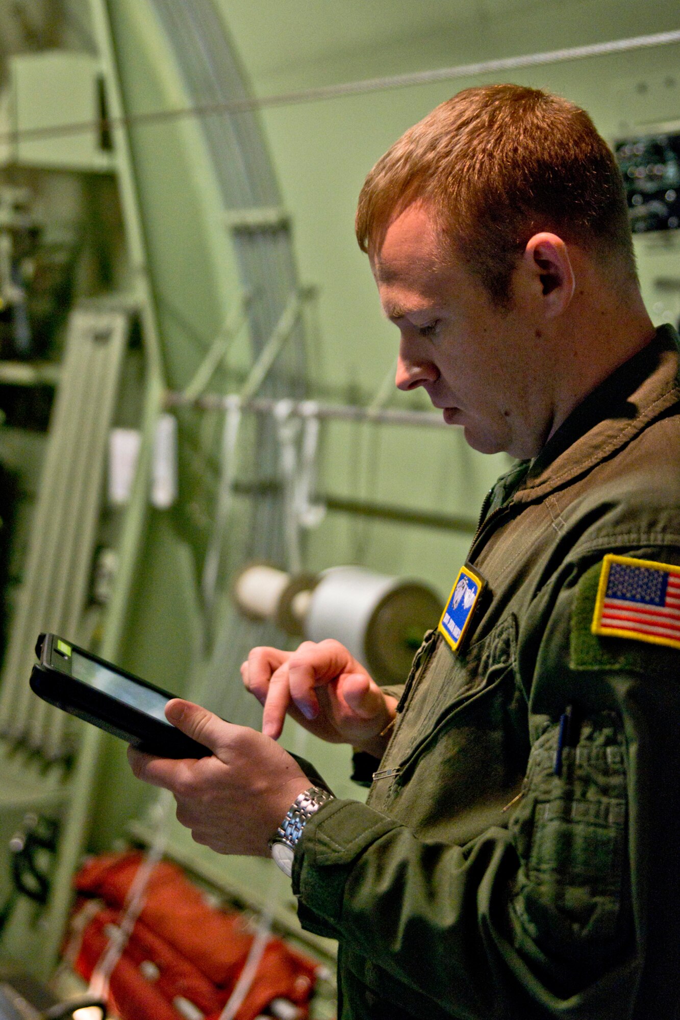 U.S. Air Force Reserve Master Sgt. Joshua Hames, a loadmaster assigned to the 327th Airlift Squadron, refers to his Electronic Flight Bag (EFB), the Air Force term for an iPad, on how he should rig the extraction parachute to the load at Little Rock Air Force Base, Ark., Feb. 16, 2016. Hames is in upgrade training as part of the 913th Airlift Group’s transition from the “H” model to the “J” model, and is trained to use the EFB in order to complete certain tasks. (U.S. Air Force photo by Master Sgt. Jeff Walston/Released)
  
