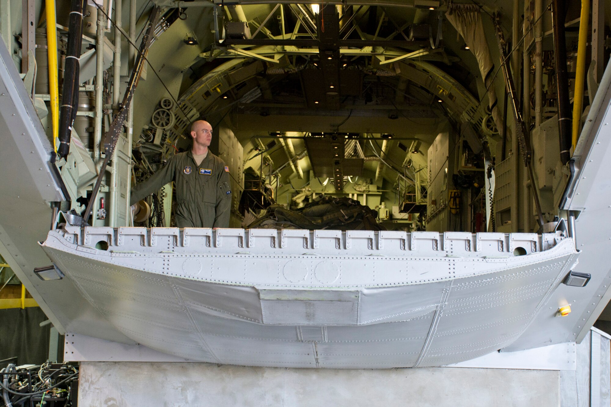 U.S. Air Force Reserve Master Sgt. Tim Brown, a loadmaster assigned to the 327th Airlift Squadron, tests the ramp and door system of a C-130 fuselage trainer (FuT) at the U.S. Air Force C-130 Aircrew Training System schoolhouse at Little Rock Air Force Base, Ark., Feb. 16, 2016. The 913th Airlift Group is transitioning from the C-130H Hercules to the C-130J Super Hercules, and aircrew personnel from the group use the FuT for retraining and certification on the new airframe. (U.S. Air Force photo by Master Sgt. Jeff Walston/Released)