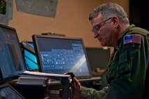 U.S. Air Force Reserve Chief Master Sgt. Donald Tarrance, superintendent, 327th Airlift Squadron, simulates powering up an aircraft in a C-130 Super Hercules Aircrew Training System at Little Rock Air Force Base, Ark., Dec. 2, 2015. Tarrance is in upgrade training as part of the 913th Airlift Group’s transition from the “H” model to the “J” model. (U.S. Air Force photo by Master Sgt. Jeff Walston/Released)