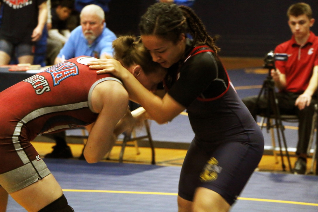 Army Sgt. Sally Roberts (red) of Fort Carson, Colo. defeats Navy Petty Officer 3rd Class Abril Ramirez of the USS Halsey for gold in the women's 63kg freestyle match of the Armed Forces Championship.  