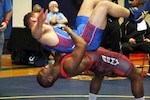 Army Sgt. Caylor Williams (red) of Fort Carson, Colo throws Marine 1st lt. Daniel Miller (blue) of Camp Lejeune, N.C. on his way to Armed Forces Gold in the 98kg Greco-Roman competition of the 2016 Armed Forces Wrestling Championship, part of the #Road2IowaCity series.  The Armed Forces Greco-Roman Championship serves as a qualifying event for the USA Wrestling Olympic Trials held in Iowa City, Iowa from 8-10 April. 