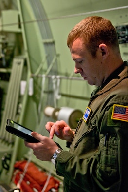 U.S. Air Force Reserve Master Sgt. Joshua Hames, a loadmaster assigned to the 327th Airlift Squadron, refers to his Electronic Flight Bag, on how he should rig the extraction parachute to the load at Little Rock Air Force Base, Ark., Feb. 16, 2016. Hames is in upgrade training as part of the 913th Airlift Group’s transition from the “H” model to the “J” model, and is trained to use the EFB in order to complete certain tasks. (U.S. Air Force photo by Master Sgt. Jeff Walston/Released)
  
