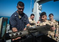 (Feb. 15, 2016) Gunner’s Mate 1st Class Christopher Lamotte, assigned to the Arliegh Burke-class guided-missile destroyer USS Russell (DDG 59), dismounts a .50 cal to demonstrate how to properly perform maintenance to Iraqi Navy Sailors assigned to Iraqi Swift Boat (P-308) during a Iraqi bilateral exercise. The U.S. participates in bilateral exercises with partner nations in order to build and strengthen solid partnerships throughout the region. Commander, Task Force 55 controls surfaces including U.S. Navy coastal patrol craft and U.S. Coast Guard patrols boats in the U.S. 5th Fleet area of operations. U.S. 5th Fleet continues to expand its relationship with the Iraqi navy through key leader engagements, professional exchanges, and conduct exercises to ensure success as a capable force able to defend its territorial waters in the Arabian Gulf.
