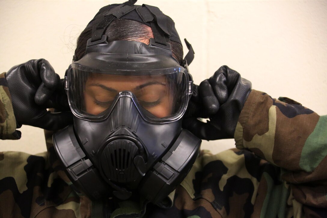 A Marine breaks the seal in her M50 Joint Service General Purpose Mask during gas chamber training at Marine Corps Air Station Cherry Point, N.C., Feb. 10, 2016. Marines with Marine Aviation Logistics Squadron 14 faced the CS gas as part of their qualification to familiarize themselves with the equipment and skills if faced with a biochemical attack. Marines of every military occupational specialty must be proficient with the equipment as it is part of every Marines’ basic skills. (U.S. Marine Corps photo by Cpl. N.W. Huertas/Released)
