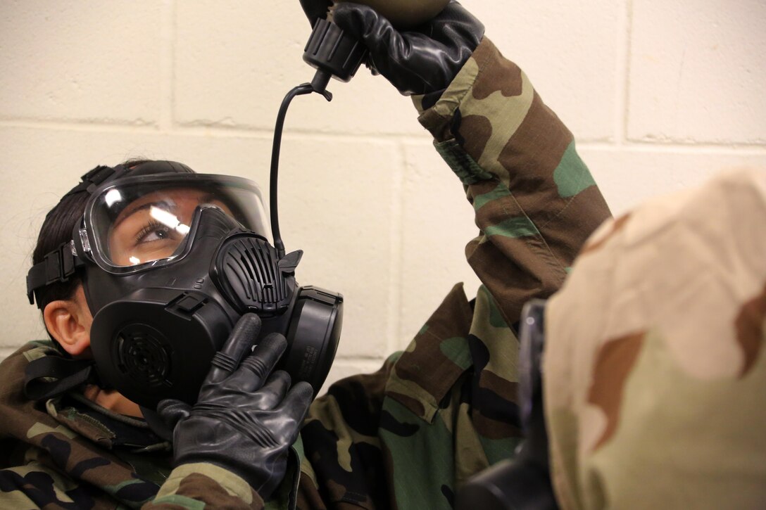 A Marine breaks the seal in her M50 Joint Service General Purpose Mask during gas chamber training at Marine Corps Air Station Cherry Point, N.C., Feb. 10, 2016. Marines with Marine Aviation Logistics Squadron 14 faced the CS gas as part of their qualification to familiarize themselves with the equipment and skills if faced with a biochemical attack. Marines of every military occupational specialty must be proficient with the equipment as it is part of every Marines’ basic skills. (U.S. Marine Corps photo by Cpl. N.W. Huertas/Released)