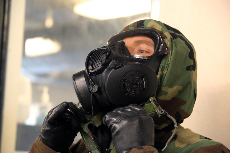 A Marine adjusts his M50 Joint Service General Purpose Mask during gas chamber training at Marine Corps Air Station Cherry Point, N.C., Feb. 10, 2016. Marines with Marine Aviation Logistics Squadron 14 faced the CS gas as part of their qualification to familiarize themselves with the equipment and skills if faced with a biochemical attack. Marines of every military occupational specialty must be proficient with the equipment as it is part of every Marines’ basic skills. (U.S. Marine Corps photo by Cpl. N.W. Huertas/Released)