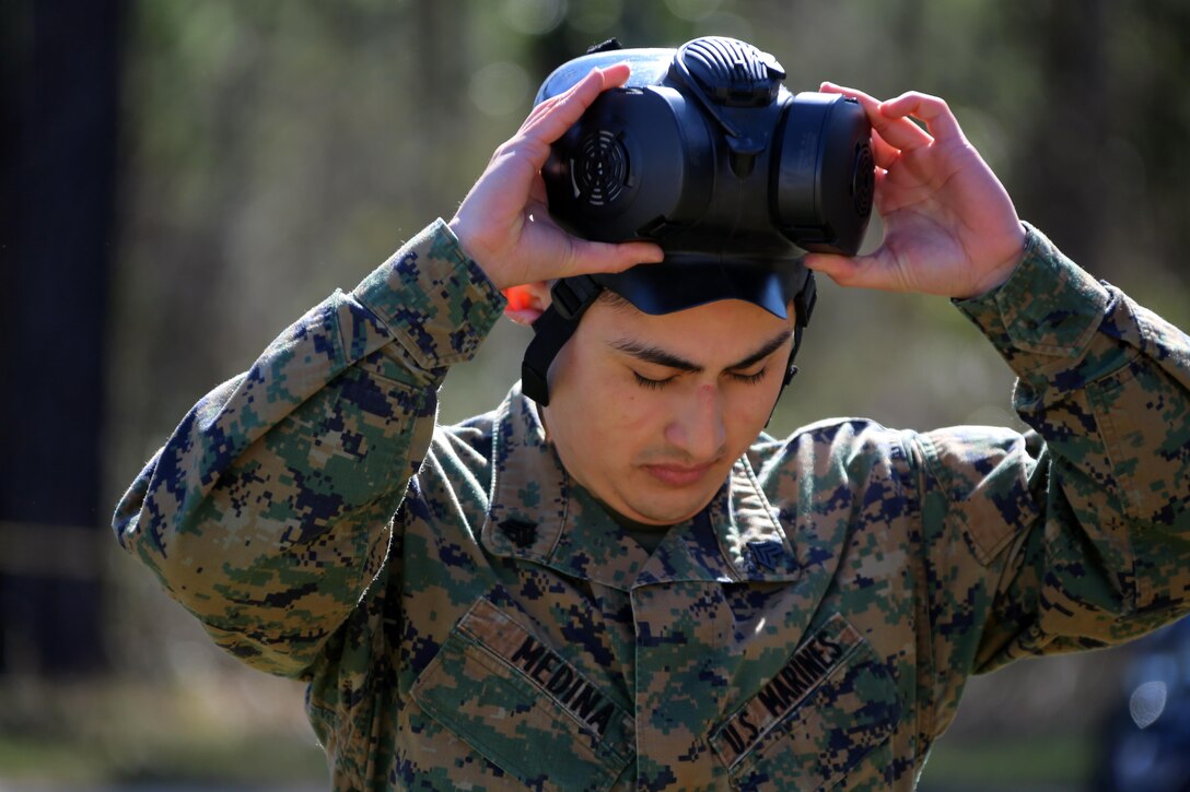 Sgt. Joseph M. Medina removes his M50 Joint Service General Purpose Gas Mask after exciting the gas chamber at Marine Corps Air Station Cherry Point, N.C., Feb. 10, 2016. Marines with Marine Aviation Logistics Squadron 14 faced CS gas in the gas chamber as part of their qualification to familiarize themselves with the equipment and skills if faced with a biochemical attack. Marines of every military occupational specialty must be proficient with the equipment as it is part of every Marines’ basic skills. Medina is an aviation supply clerk with Marine Aviation Logistics Squadron 14. (U.S. Marine Corps photo by Cpl. N.W. Huertas/Released)