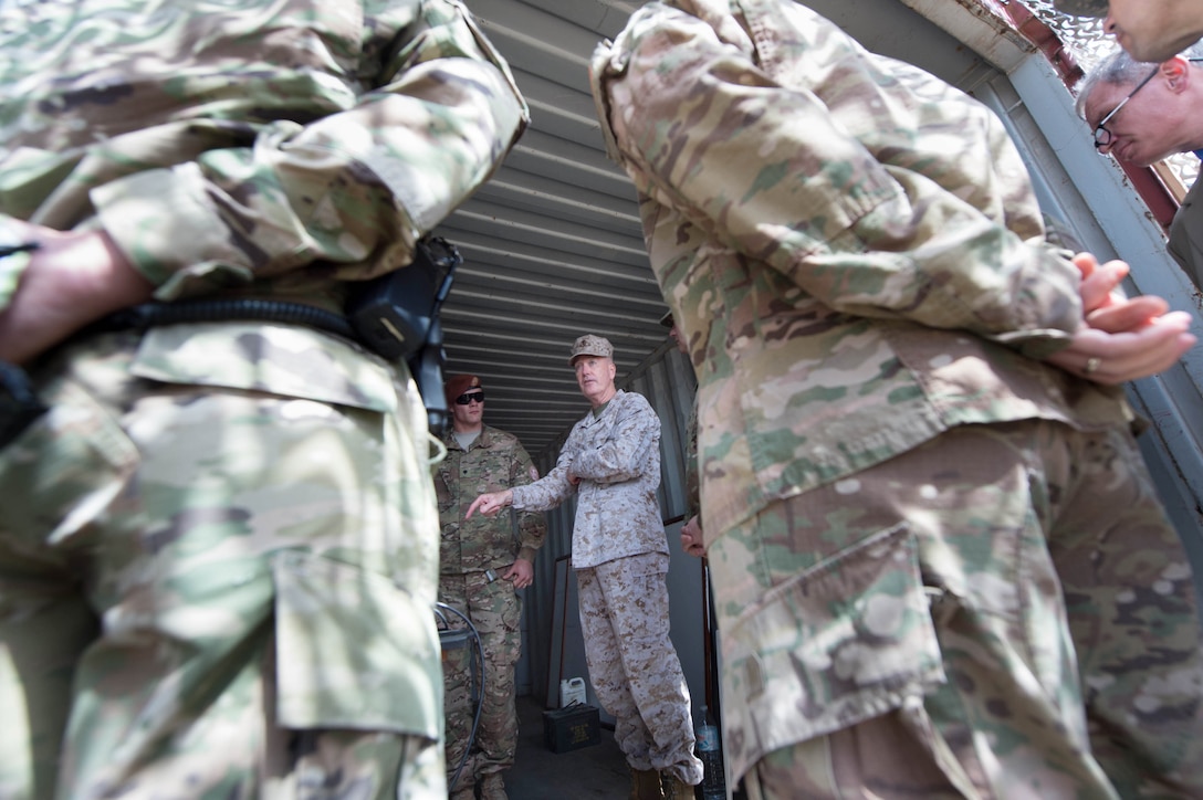 Marine Corps Gen. Joseph F. Dunford Jr., center, chairman of the Joint Chiefs of Staff, listens to a brief during a visit to the North Camp in the Sinai Peninsula of Egypt, Feb. 21, 2016. DoD photo by D. Myles Cullen