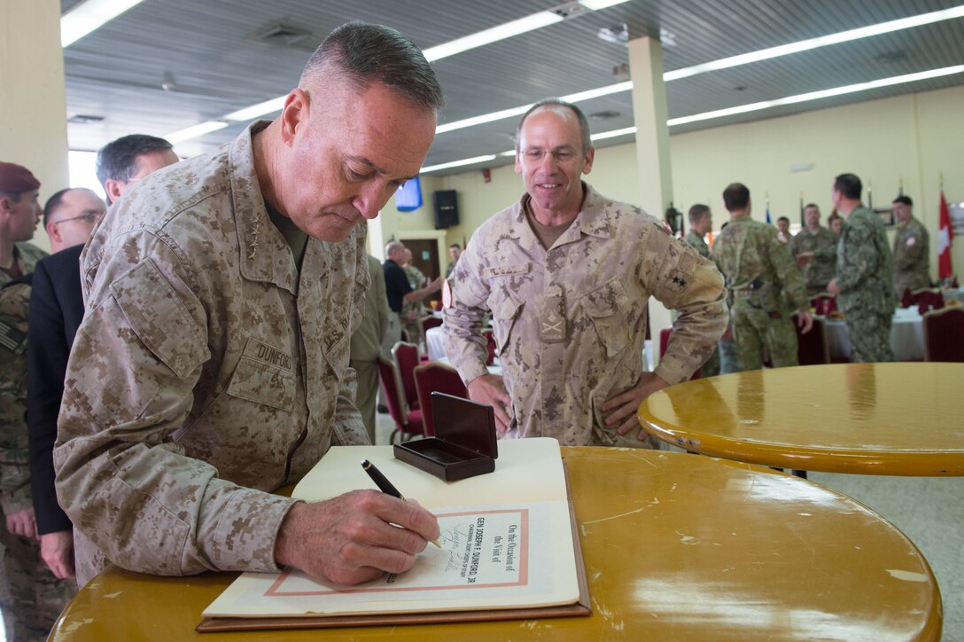 Marine Corps Gen. Joseph F. Dunford Jr., chairman of the Joint Chiefs of Staff, signs a guest book before having lunch with service members assigned to the Multinational Force and Observers at the North Camp in the Sinai Peninsula of Egypt, Feb. 21, 2016. DoD photo by D. Myles Cullen 