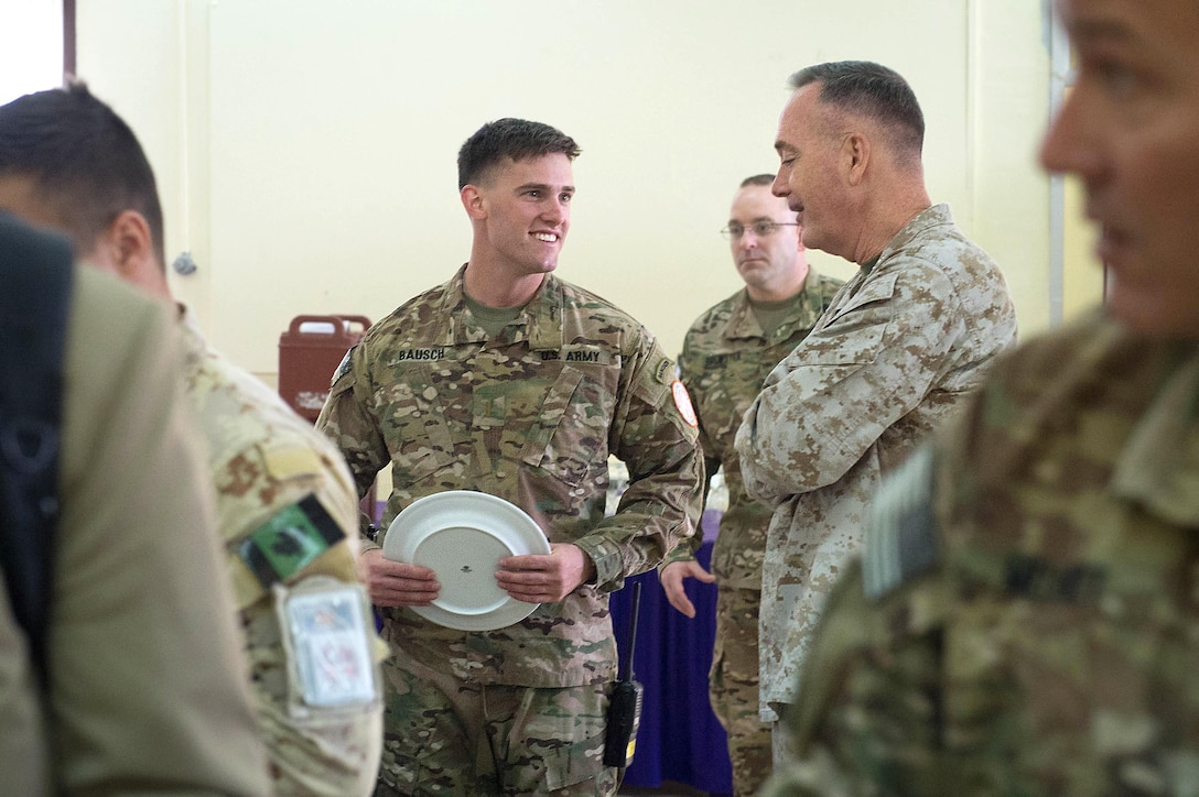Marine Corps Gen. Joseph F. Dunford Jr., chairman of the Joint Chiefs of Staff, talks with Army 2nd Lt. Bausch while waiting in line for lunch on the North Camp of the Multinational Force and Observers in the Sinai Peninsula of Egypt, Feb. 21, 2016. DoD photo by D. Myles Cullen