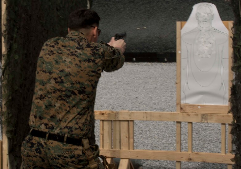 Sgt. Martin Lucero fires his M9 pistol at a target while demonstrating the course of fire titled, “James Bond” to the competitors Feb. 18 during a three-gun shooting competition aboard Camp Hansen, Okinawa, Japan. Lucero traveled to Okinawa from Quantico, Virginia to coach Marines participating in the shooting competition where Marines shot the M9 pistol, M1014 shotgun and the M16A4 service rifle. “We teach the Marines how to be more effective in combat with their standard issued weapons systems,” said Lucero. “We travel, we learn new tactics and we give that knowledge back to the Marines.” Lucero, a Denver, Colorado, native, is a competitor instructor for the U.S. Marine Corps Combat Shooting Team. (U.S. Marine Corps Photo by Cpl. Brittany A. James/ Released)