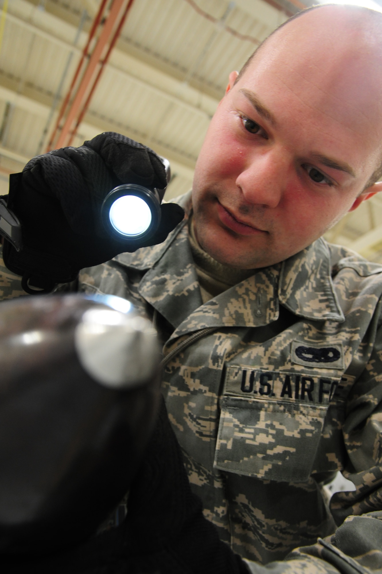 U.S. Air Force Senior Airman Nicholas McClary, a weapons specialist from the 509th Munitions Squadron, inspects a training asset at Whiteman Air Force Base, Mo., Feb. 12, 2016. The inspection verifies there’s no damage done to the weapon after maintenance has been performed. (U.S. Air Force photo by Senior Airman Keenan Berry)