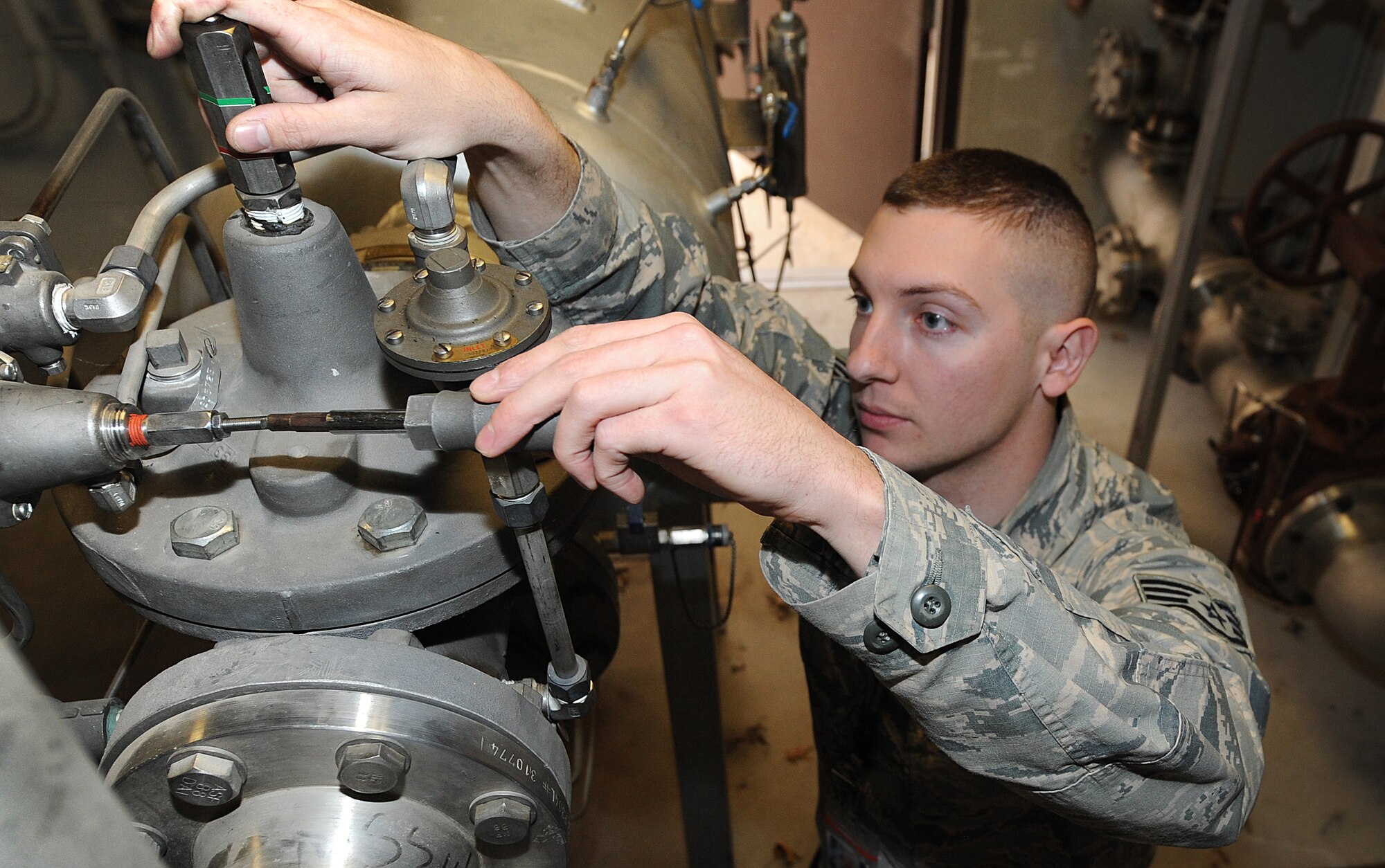 U.S. Air Force Staff Sgt. Daniel Huffstetler, the 509th Civil Engineer Squadron water and fuels systems maintenance supervisor, adjusts the rate of flow for filter separators at Whiteman Air Force Base, Mo., Feb. 12, 2016. Unlike other systems, the Type 5 fueling system allows the B-2 Spirit to be fueled inside the hangar; this provides the B-2 with a strategic advantage.  (U.S. Air Force photo by Airman 1st Class Michaela R. Slanchik)