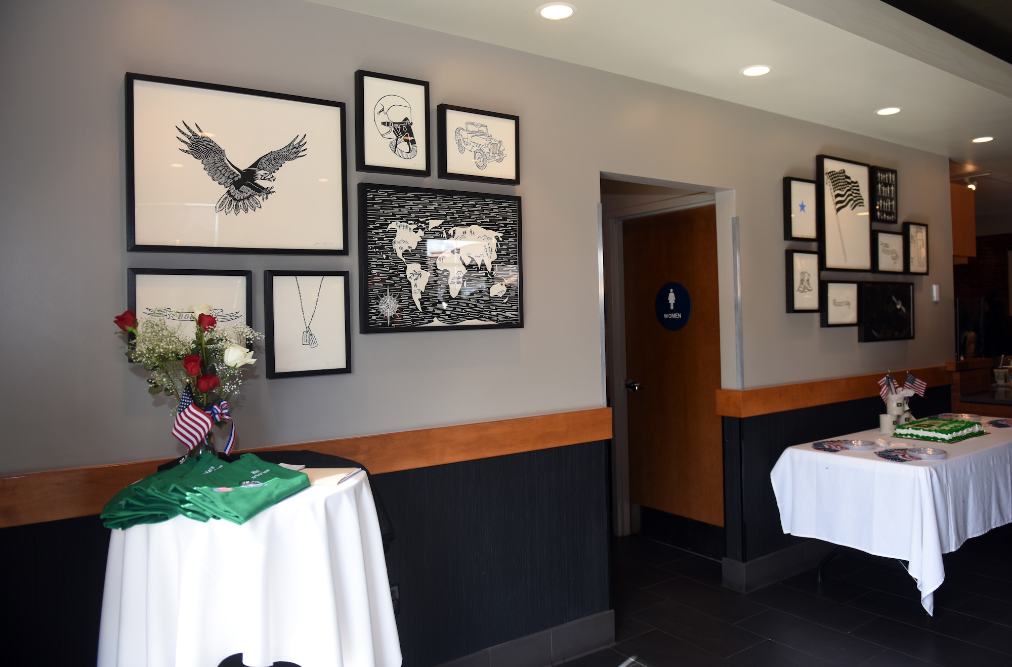 A wall of art is revealed during a Military Family Store dedication, Feb. 18, 2016, at Starbucks in Lompoc, Calif. The art is meant to honor the military working for Starbucks and local military members. (U.S. Air Force photo by Senior Airman Kyla Gifford/Released)