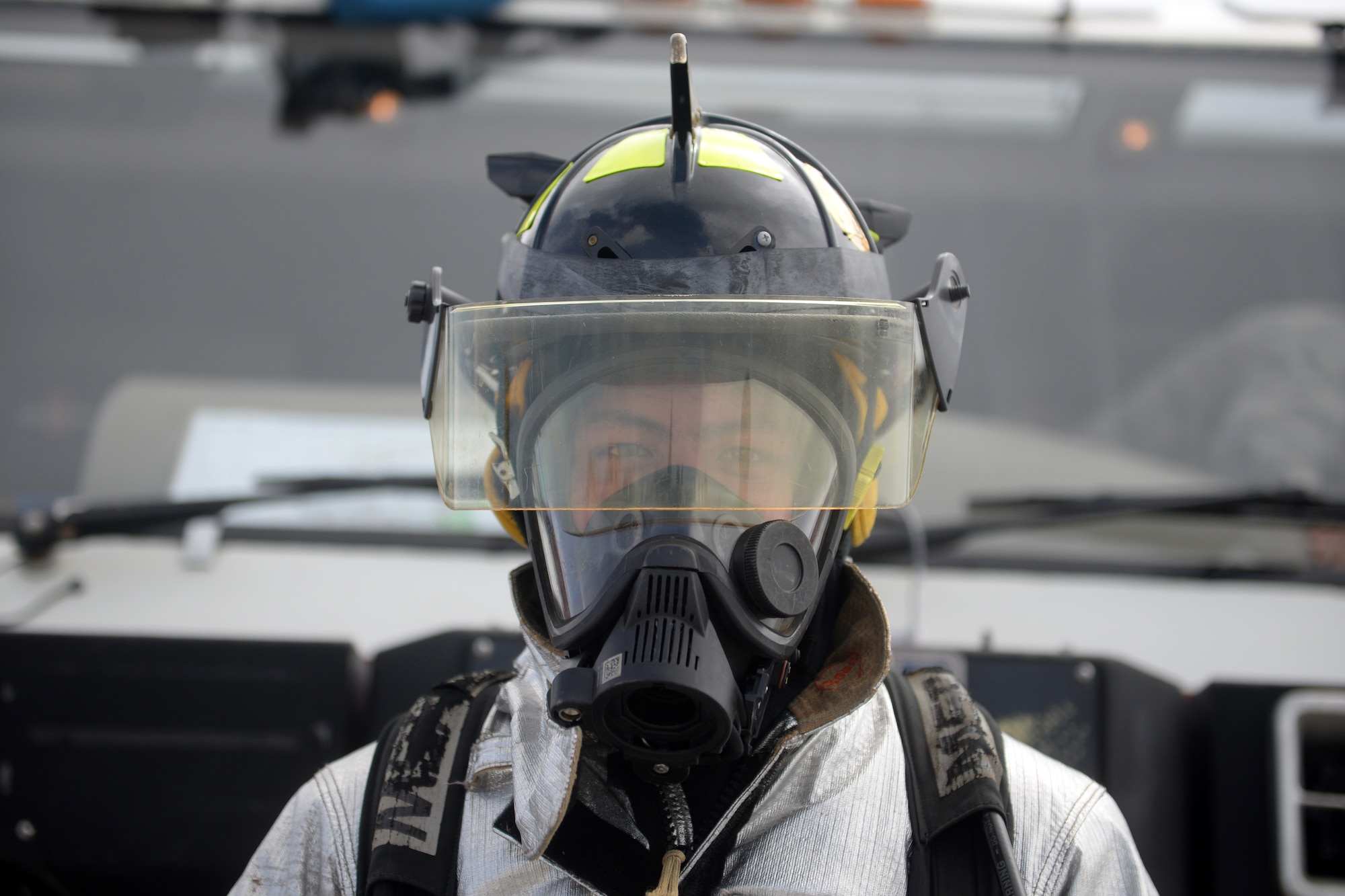 Airman 1st Class Niko Diego, 36th Civil Engineer Squadron firefighter, stands for a photo Feb. 20 during a fire truck demonstration at the 2016 Pacific Air Partners Open House at Andersen Air Force Base, Guam. Diego, alongside other members of the fire department, provided attendees the opportunity to sit in a fire truck and learn about their mission. (U.S. Air Force photo/Senior Airman Joshua Smoot)
