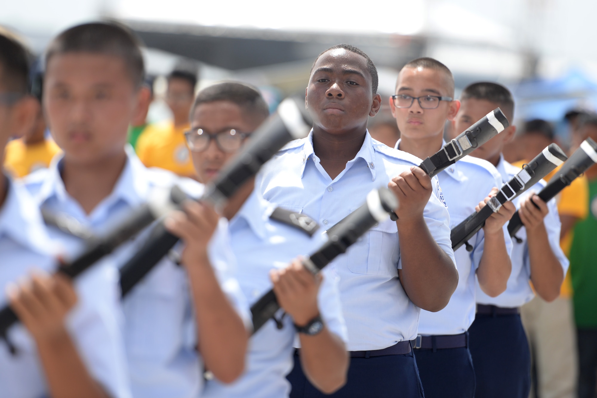 Drill members with the John F. Kennedy High School Junior Reserve Officer Training Corps hold rifles during a routine Feb. 20 during the 2016 Pacific Air Partners Open House at Andersen Air Force Base, Guam.  In addition to their presentation, drill teams from Guam High School and Okkodo High School performed for the crowd during the open house. (U.S. Air Force photo/Senior Airman Joshua Smoot)