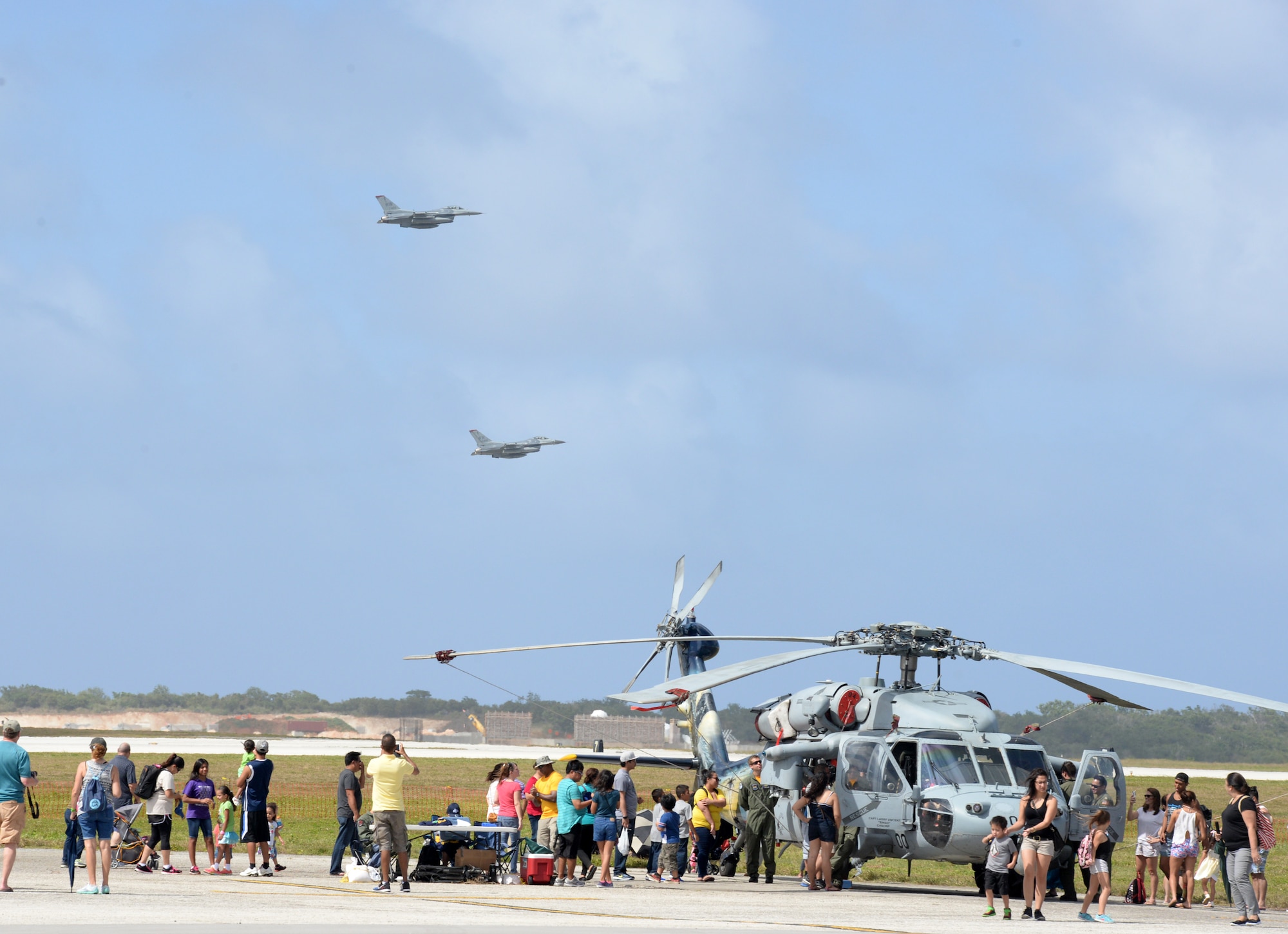 F-16 Fighting Falcons fly over the flightline Feb. 20 during the 2016 Pacific Air Partners Open House at Andersen Air Force Base, Guam.  The largest community outreach event of the year, the open house aimed to enhance public awareness of the U.S. military's mission, equipment, facilities and personnel and to promote positive community relations. (U.S. Air Force photo/Senior Airman Joshua Smoot)