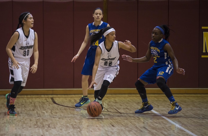 The Zama Trojans from Camp Zama, Japan, take control of the ball during the 2016 Division 2 Girls’ Far East Basketball Tournament championship game at Matthew C. Perry High School at Marine Corps Air Station Iwakuni, Japan, Feb. 18, 2016. For the second year in a row the Yokota Panthers from Yokota Air Base, Japan, took the trophy with a score of 50-24.