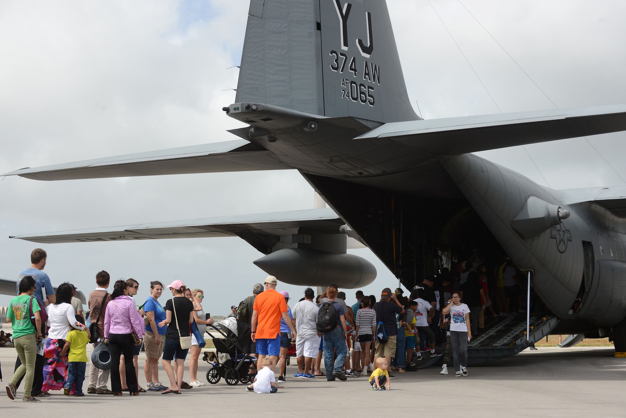 Crowds of people line up to see a C-130 Hercules Feb. 20 during the 2016 Pacific Air Partners Open House at Andersen Air Force Base, Guam. The event included multiple aircraft static displays, flyovers, ground demonstrations and live bands.(U.S. Air Force photo/Airman 1st Class Arielle Vasquez)