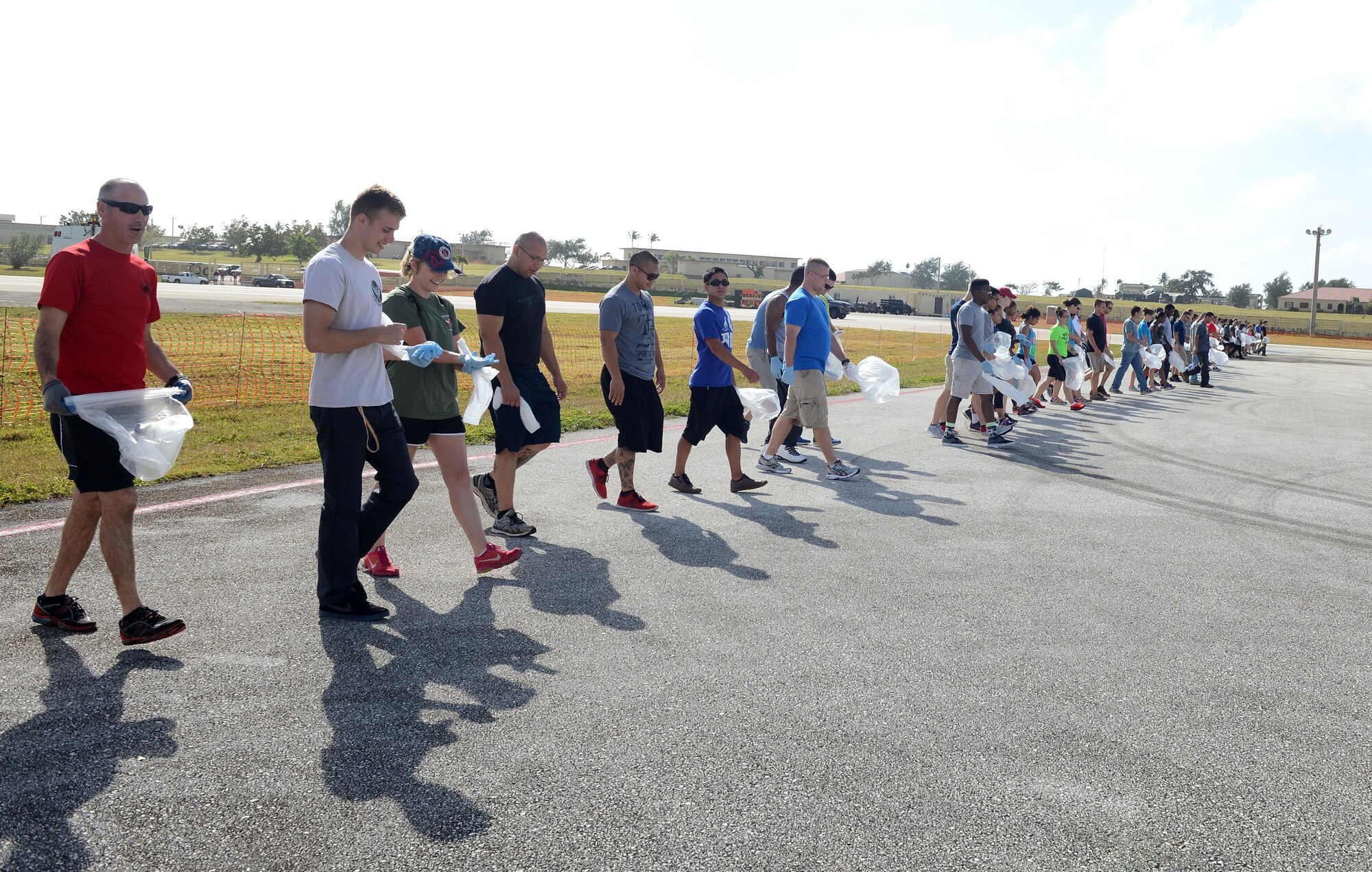 Airmen conducted a foreign object damage walk Feb. 21, 2016, at Andersen Air Force Base, Guam. The FOD walk was conducted after the 2016 Pacific Air Partners Open House to ensure no debris was left on the flightline, which could affect aircraft engines. (U.S. Air Force photo/Airman 1st Class Arielle Vasquez)