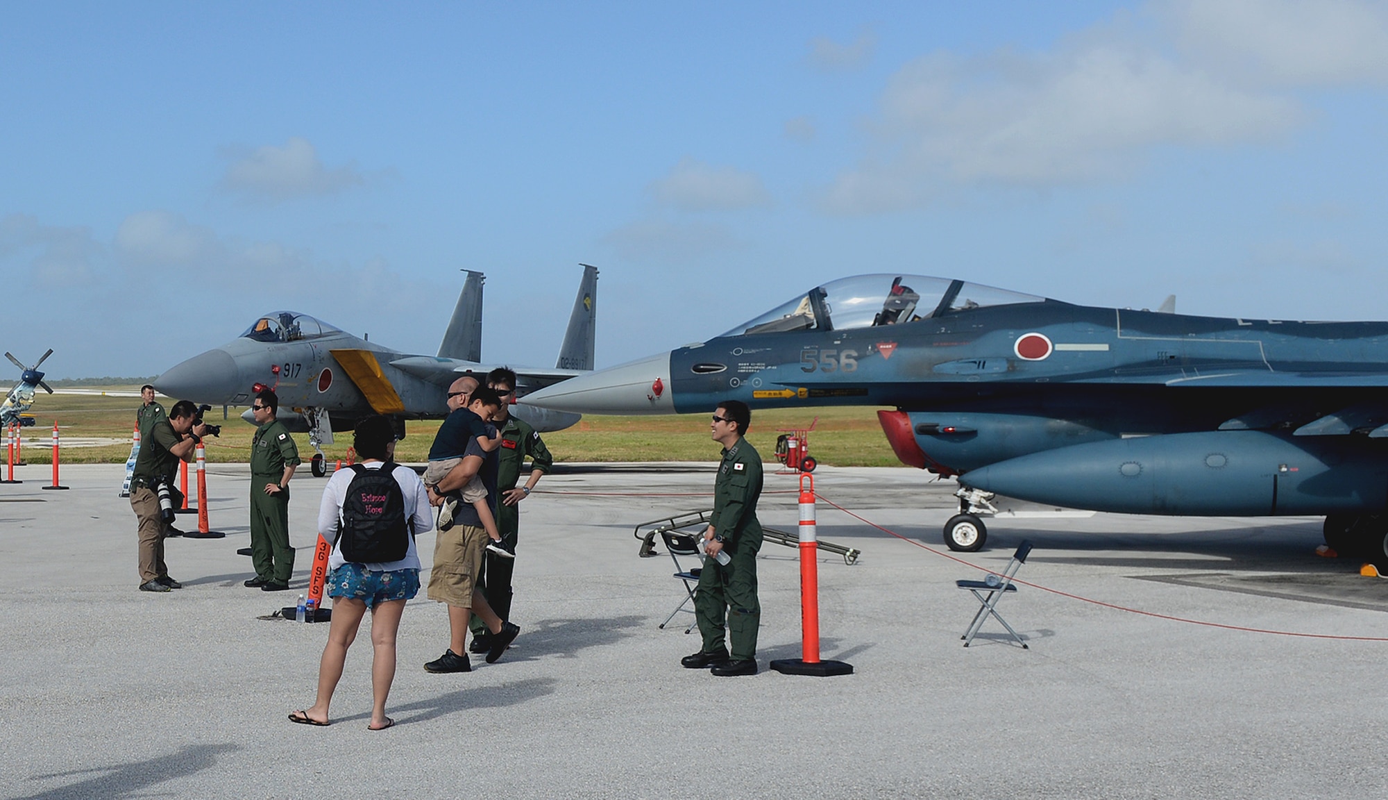 Japan Air Self-Defense Force Airmen interact with visitors of the 2016 Pacific Air Partners Open House Feb. 20 at Andersen Air Force Base, Guam. At the open house, the JASDF had multiple aircraft out on display to include the F-15J Eagle and F-2 Viper Zero. The JASDF and Royal Australian Air Force joined the U.S. Air Force in demonstrating pacific airpower to the attendees of the open house. (U.S. Air Force photo/Staff Sgt. Benjamin Gonsier)