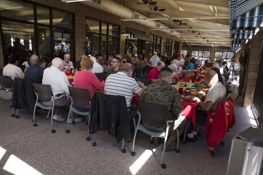 Veterans from the Battle of Iwo Jima and their families share a lunch with Marines during a tour of Marine Corps Air Station Miramar, Calif., Feb. 19, 2016. Marine Corps photo by Sgt. Brian Marion
