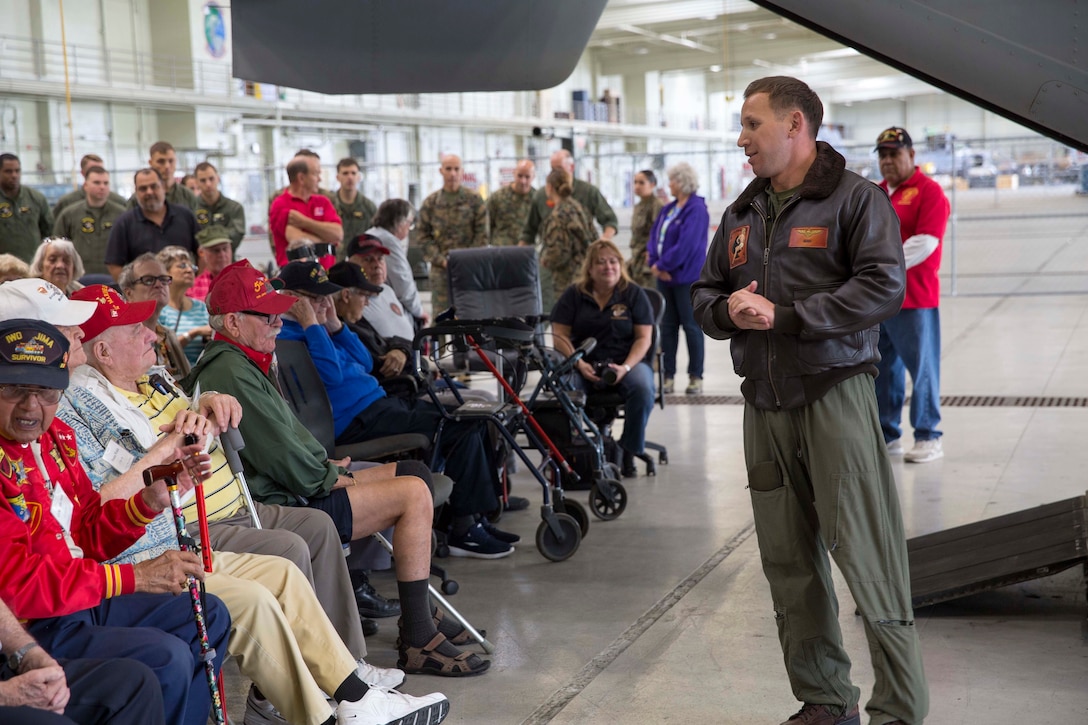 Marine Corps Capt. Evan Bernstein, right, speaks to veterans of the Battle of Iwo Jima and their families during a tour on Marine Corps Air Station Miramar, Calif., Feb. 19, 2016. More than 75 veterans and their family members toured the station to commemorate the 71st anniversary of the battle. Bernstein is an MV-22B Osprey pilot assigned to Marine Medium Tiltrotor Squadron 165. Marine Corps photo by Sgt. Brian Marion
