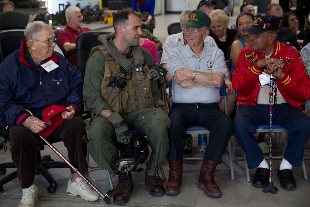 Marine Corps Capt. Paul Keller, second from left, talks with the Battle of Iwo Jima veterans during a tour on Marine Corps Air Station Miramar, Calif., Feb. 19, 2016. Keller is an MV-22B Osprey pilot assigned to Marine Medium Tiltrotor Squadron 165. Marine Corps photo by Sgt. Brian Marion