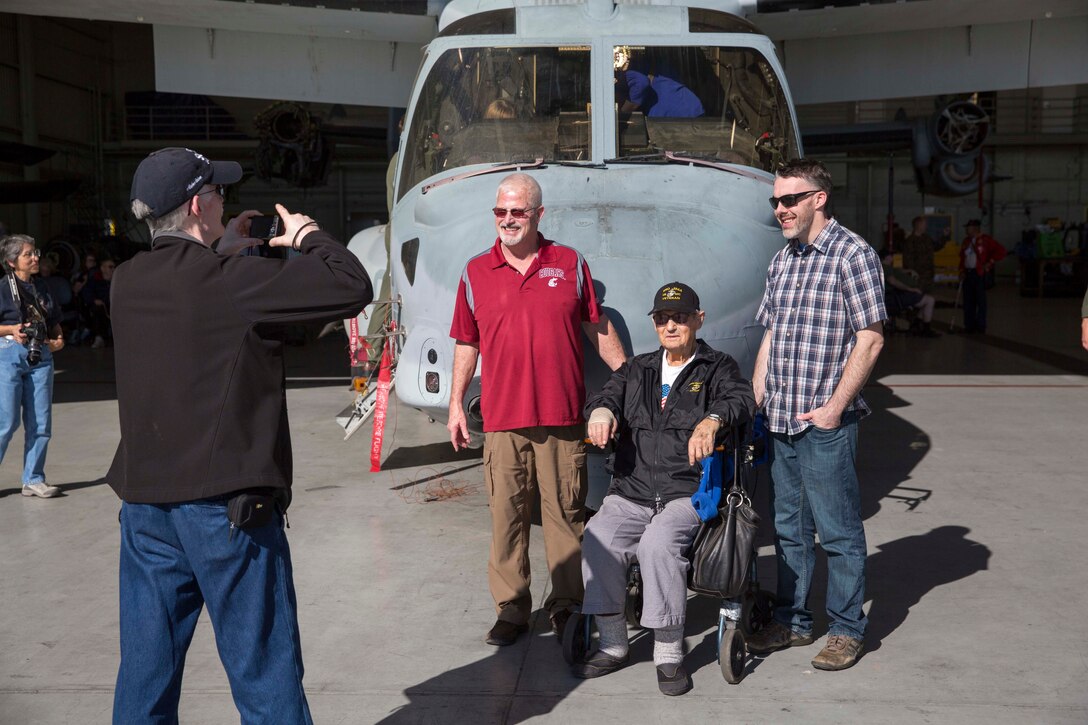 Veterans of the Battle of Iwo Jima and their families take pictures in front of an MV-22B Osprey aircraft during a tour on Marine Corps Air Station Miramar, Calif., Feb. 19, 2016. Marine Corps photo by Sgt. Brian Marion