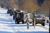 Vampire Soldiers from the Joint Multinational Readiness Center (JMRC) align vehicles in a staggered formation during a react to contact movement Jan. 22 in Allied Spirit IV, a multinational exercise at the U.S. Army’s Joint Multinational Readiness Center in Hohenfels Training Area (JMRC HTA), Germany. (U.S. Army National Guard photo by Staff Sgt. Eddie Siguenza)