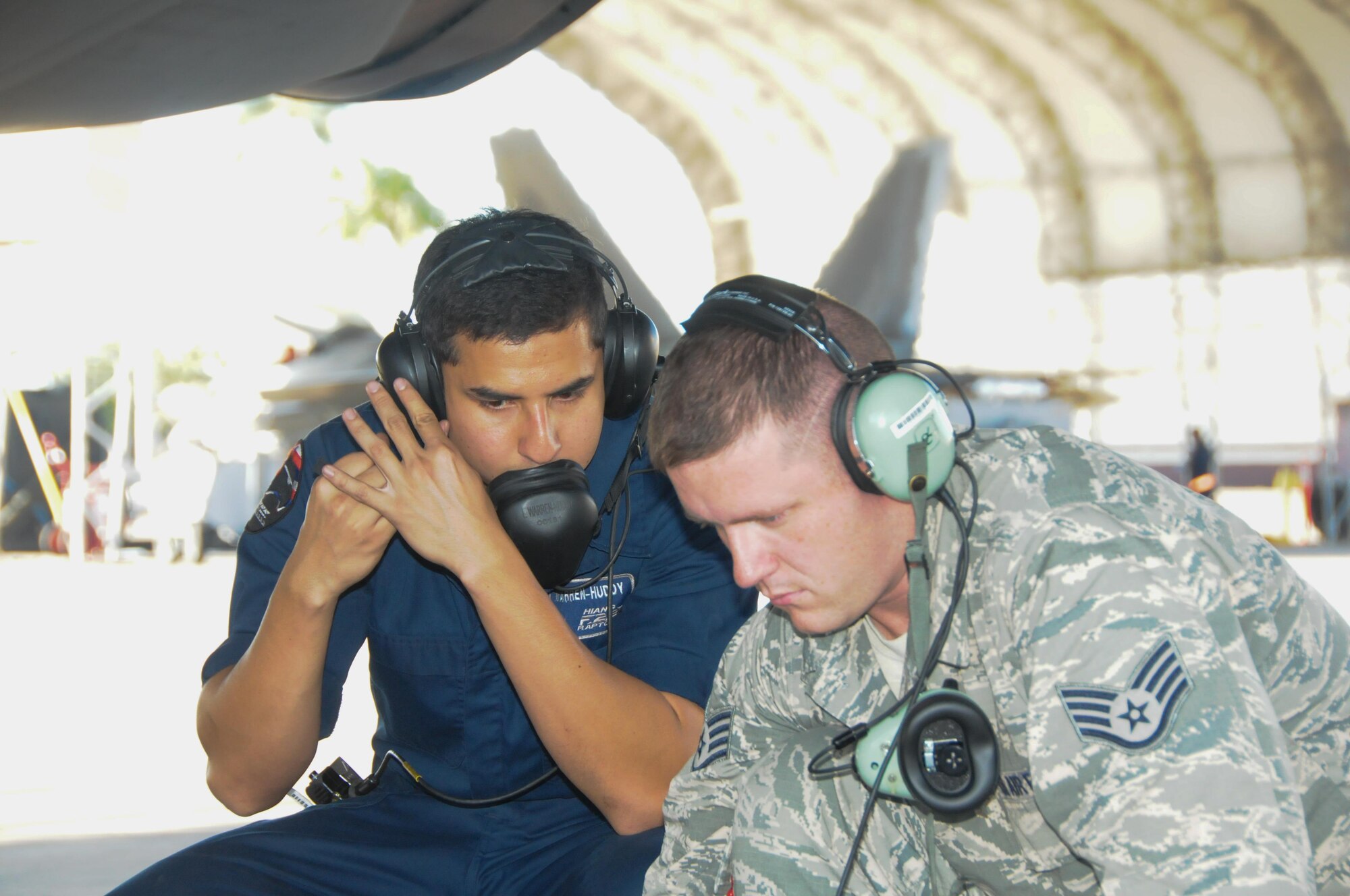 Airmen from the Hawaii based 154th Maintenance Squadron and the Alaska based 477th MXS, work together on a Hawaii Air National Guard F-22 Raptor at Joint Base Pearl Harbor-Hickam, Feb. 5, 2016. While on temporary duty in Hawaii, the 477th MXS airmen assisted counterparts at the 154th MXS with maintenance on the Hawaiian Raptors. (U.S. Air National Guard photo by Senior Airman Orlando Corpuz/released)