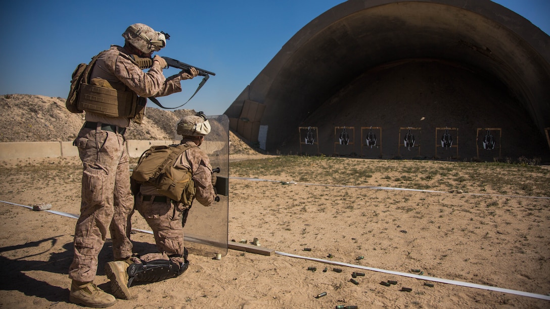 U.S. Marine Corps Lance Cpl. Andrew Decker (standing) and Lance Cpl. Kenny Trygstab with Charlie Company, 1st Battalion, 7th Marine Regiment, attached to Special Purpose Marine Air-Ground Task Force-Crisis Response-Central Command, conduct non-lethal weapons training at an undisclosed location in Southwest Asia, Feb. 2, 2016.  SPMAGTF-CR-CC Marines hone their skills in the event of non-lethal combatant operations. 