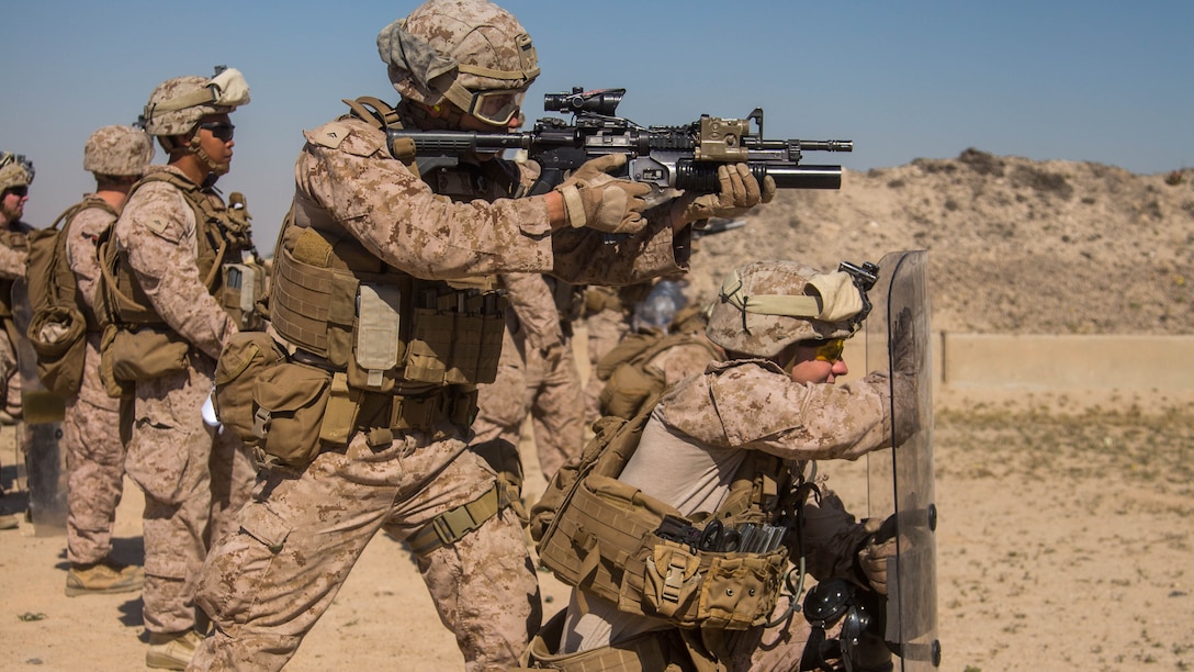U.S. Marine Lance Cpl. Tanner Walker (standing) and Lance Cpl. Kenny Trygstab (kneeling) with Charlie Company, 1st Battalion, 7th Marine Regiment, attached to Special Purpose Marine Air-Ground Task Force-Crisis Response-Central Command, conduct non-lethal weapons training at an undisclosed location in Southwest Asia, Feb. 2, 2016. SPMAGTF-CR-CC Marines hone their skills in the event of non-lethal combatant operations. 