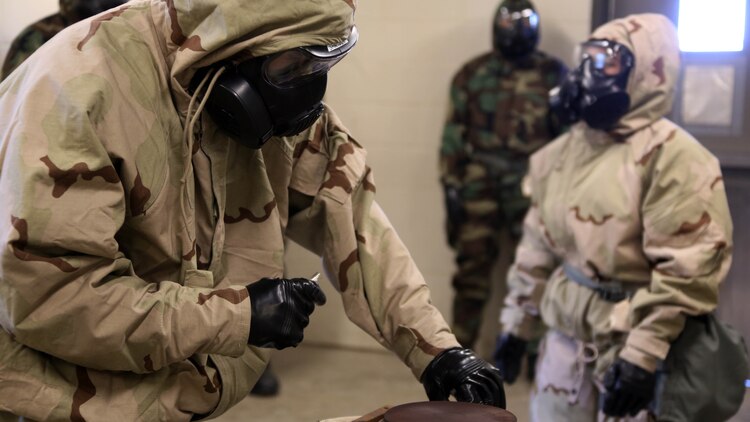 Cpl. Jeremy W. Case lights a hot plate to release CS gas during gas chamber training at Marine Corps Air Station Cherry Point, N.C., Feb. 10, 2016. Marines with Marine Aviation Logistics Squadron 14 faced the CS gas as part of their qualification to familiarize themselves with the equipment and skills if faced with a biochemical attack. Marines of every military occupational specialty must be proficient with the equipment as it is part of every Marines’ basic skills. Case is a Chemical, Biological, Radiologicl and Nuclear defense specialist with Marine Wing Headquarters Squadron 2. 