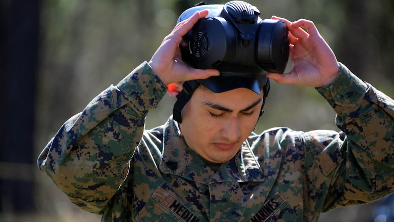 Sgt. Joseph M. Medina removes his M50 Joint Service General Purpose Gas Mask after exciting the gas chamber at Marine Corps Air Station Cherry Point, N.C., Feb. 10, 2016. Marines with Marine Aviation Logistics Squadron 14 faced CS gas in the gas chamber as part of their qualification to familiarize themselves with the equipment and skills if faced with a biochemical attack. Marines of every military occupational specialty must be proficient with the equipment as it is part of every Marines’ basic skills. Medina is an aviation supply clerk with Marine Aviation Logistics Squadron 14. 