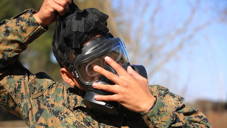 Cpl. Justin D. Espena removes his M50 Joint Service General Purpose Gas Mask after exciting the gas chamber at Marine Corps Air Station Cherry Point, N.C., Feb. 10, 2016. Marines with Marine Aviation Logistics Squadron 14 faced CS gas in the gas chamber as part of their qualification to familiarize themselves with the equipment and skills if faced with a biochemical attack. Marines of every military occupational specialty must be proficient with the equipment as it is part of every Marines’ basic skills. Espena is an aircraft maintenance  support equip hydraulic, pneumatic, structure mechanic with MALS-14. 