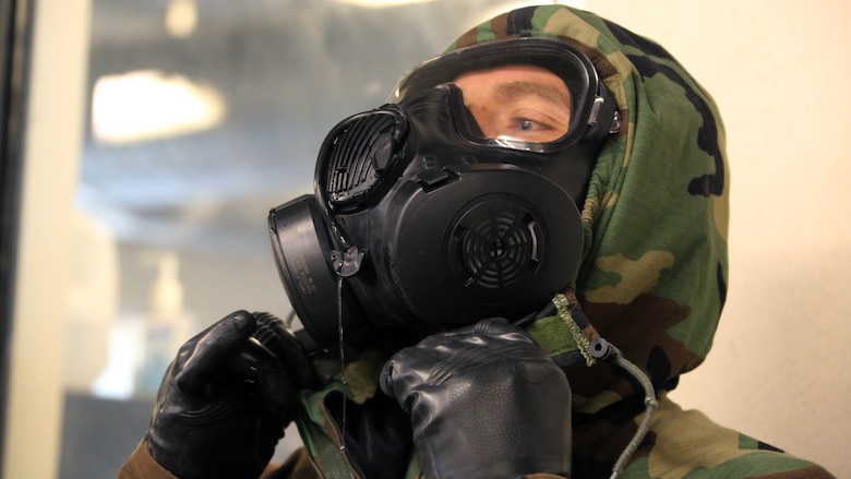 A Marine adjusts his M50 Joint Service General Purpose Mask during gas chamber training at Marine Corps Air Station Cherry Point, N.C., Feb. 10, 2016. Marines with Marine Aviation Logistics Squadron 14 faced the CS gas as part of their qualification to familiarize themselves with the equipment and skills if faced with a biochemical attack. Marines of every military occupational specialty must be proficient with the equipment as it is part of every Marines’ basic skills. 