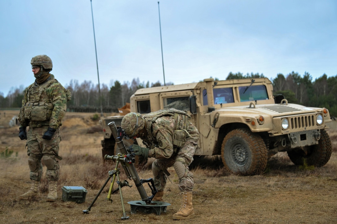 Army Spc. Danial Semenick, right, and Army Pfc. Austin Adame set up a M224 60 mm mortar system at the Drawsko Pomorskie training area, Poland, Feb. 10, 2016. Semenick and Adame, assigned to the 3rd Squadron, 2d Cavalry Regiment, are training in Poland in support of Atlantic Resolve-North, a multinational demonstration of continued U.S. commitment to the collective security of its NATO allies. Army photo by Markus Rauchenberger