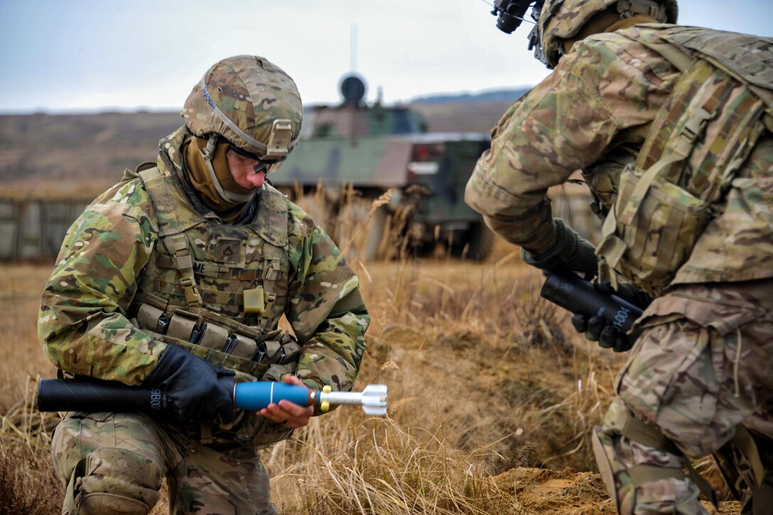 Army Pfc. Austin Adame, left, prepares a simulation round for a M224 60 mm mortar system at the Drawsko Pomorskie training area, Poland, Feb. 10, 2016. Adame is assigned to the 3rd Squadron, 2d Cavalry Regiment. Army photo by Markus Rauchenberger