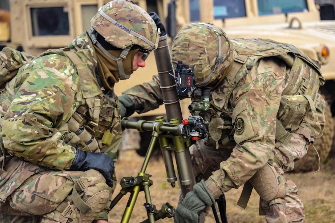 Army Spc. Danial Semenick, right, and Army Pfc. Austin Adame set up a M224 60 mm mortar system at the Drawsko Pomorskie training area, Poland, Feb. 10, 2016. Semenick and Adame are assigned to the 3rd Squadron, 2d Cavalry Regiment. Army photo by Markus Rauchenberger