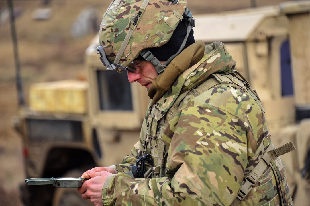 Army Staff Sgt. Adam Gibbs checks his compass during a M224 60 mm mortar system fire mission at the Drawsko Pomorskie training area, Poland, Feb. 10, 2016. Gibbs is assigned to the 3rd Squadron, 2d Cavalry Regiment. Army photo by Markus Rauchenberger