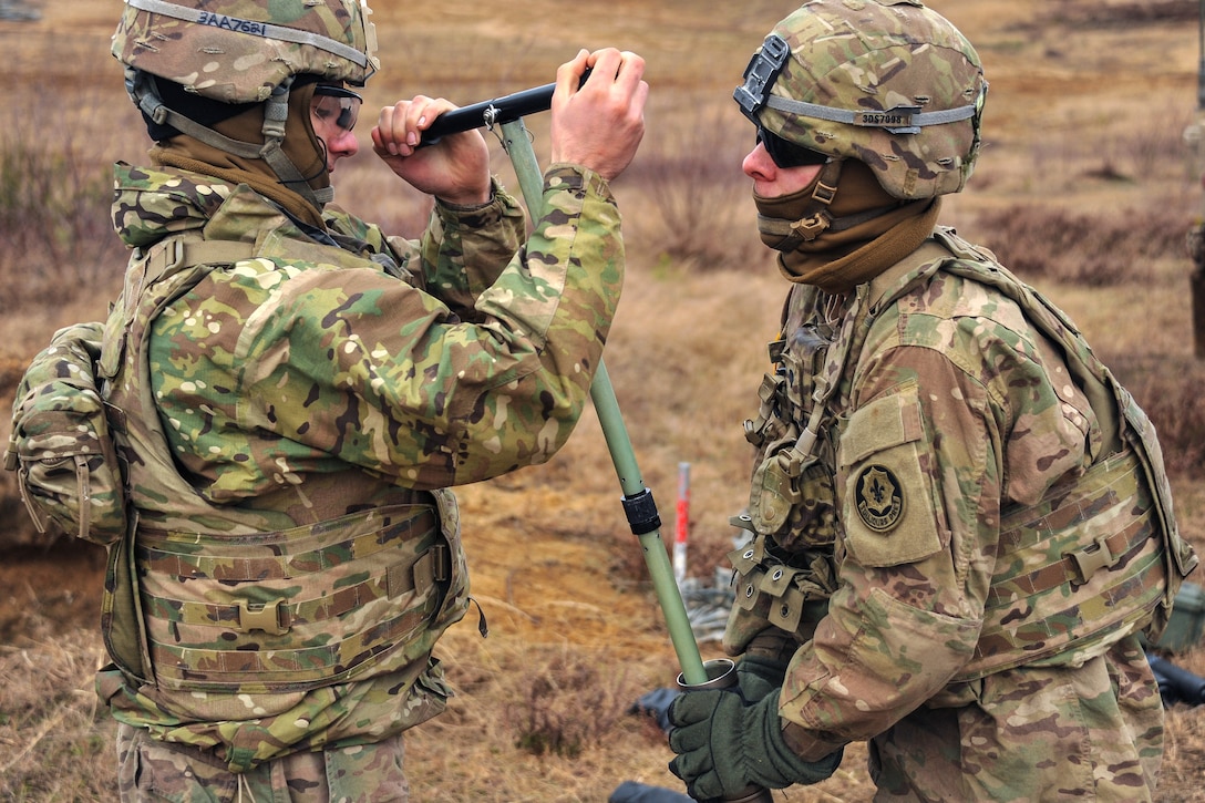 Army Spc. Danial Semenick, right, and Army Pfc. Austin Adame clean a M224 60 mm mortar system after firing simulation rounds on the Drawsko Pomorskie training area, Poland, Feb. 10, 2016. Semenick and Adame are assigned to the 3rd Squadron, 2d Cavalry Regiment. Army photo by Markus Rauchenberger