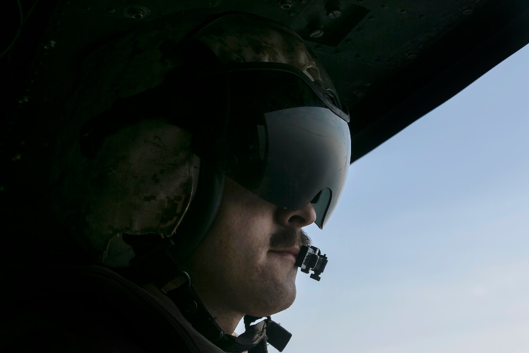 Marine Corps Cpl. Erik A. Dudley scans the horizon as naval and air assets support each other during exercise Cobra Gold 16 in Utapao, Thailand, Feb. 12, 2016. Dudley is an aerial observer and flightline mechanic assigned to Light Attack Helicopter Squadron 167. Marine Corps photo by Cpl. William Hester