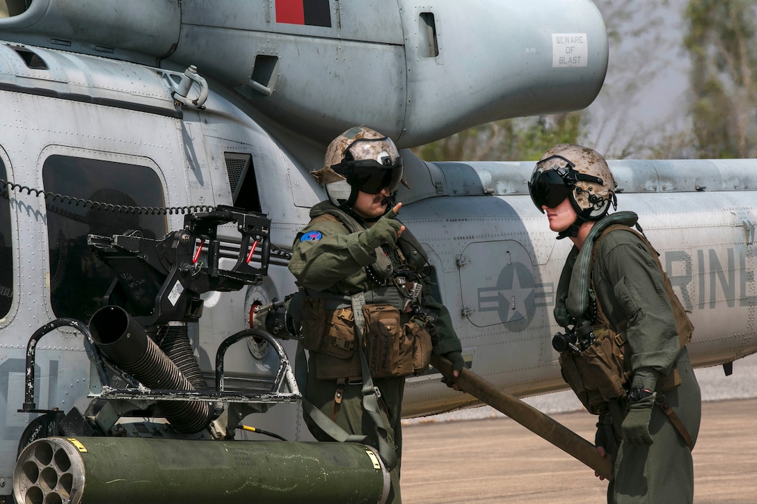 Marine Corps Cpl. Erik A. Dudley, left and Marine Corps Sgt. Kyle J. Mohr refuel a UH-1Y Huey helicopter at a forward arming and refueling point during exercise Cobra Gold 16 in Utapao, Thailand, Feb. 12, 2016. Dudley is an aerial observer and flightline mechanic and Mohr is a crew chief assigned to Light Attack Helicopter Squadron 167. Marine Corps photo by Cpl. William Hester