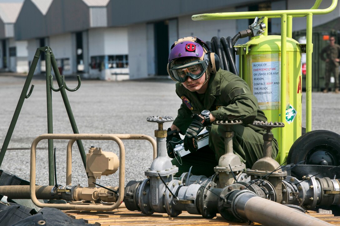 Marine Corps Cpl. Alberto Marquez manages fuel pressure while refueling a UH-1Y Huey helicopter at a forward arming and refueling point during exercise Cobra Gold 16 in Utapao, Thailand, Feb. 12, 2016. Marquez is a bulk fuel specialist assigned to Marine Wing Support Squadron 172, Marine Aircraft Group 36, 1st Marine Aircraft Wing, 3rd Marine Expeditionary Force. Marine Corps photo by Cpl. William Hester