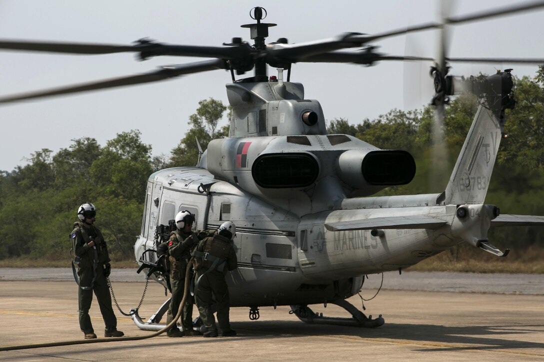 Marines refuel their UH-1Y Huey helicopter after providing security and communication during exercise Cobra Gold 16 in Thailand, Feb. 12, 2016. Marine Corps photo by Cpl. William Hester