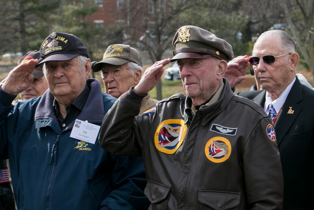 WWII veterans Ira Rigger, USN; Jerry Yellin, USAF and Gene Bell, USMC, salute during a wreath laying ceremony at the Marine Corps War Memorial, Arlington, Va., Feb. 19, 2016. Earlier that morning, a memorial service commemorating the 71st anniversary of the landing on Iwo Jima took place at Crawford Hall, Marine Barracks Washington, D.C. Iwo survivors, family and friends traveled to the National Capitol Region to take part in the Iwo Jima Association of America’s 71st Anniversary, Reunion and Symposium. (Official Marine Corps photo by Cpl. Chi Nguyen/Released)